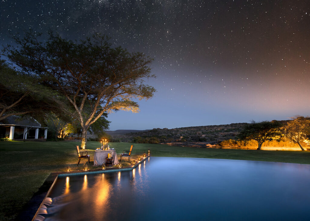 Image of the starry skies at Bushmans Kloof in the Cederberg in South Africa. An intimate candlelit dinner is set up alongside the pool for added romance. | Planet Africa Safaris | Blog | Cape Town Diva