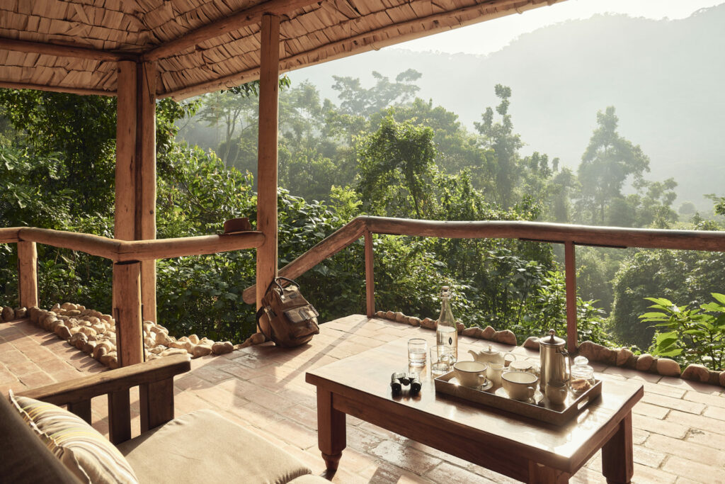 Image showing views over the Bwindi Impenetrable Forest from Sanctuary Gorilla Forest Camp in Uganda. Lush forests and luxury wooden furniture are visible creating a sense of serenity | Planet Africa Safaris | Blog | Sanctuary Retreats